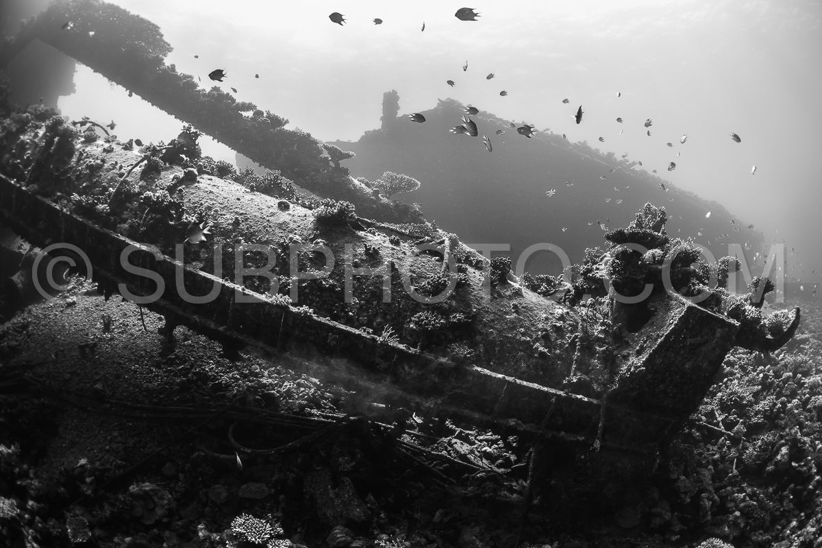 A diver explores a shipwreck in the Red Sea. The diver is using a closed-circuit rebreather to extend their dive time and minimize their impact on the environment.