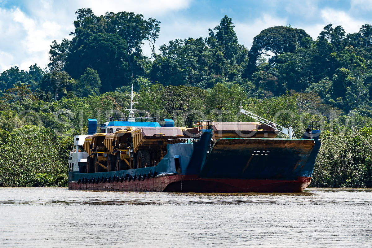 Boat carrying huge trucks for coal transportation in Berau- Kalimantan