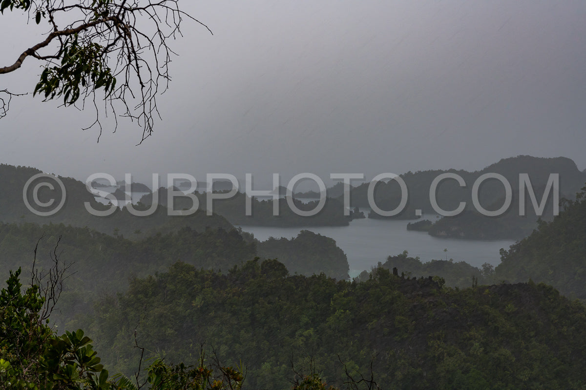 East Misool- group of small island in shallow blue lagoon water under the rain- Raja Ampat- West Papua- Indonesia