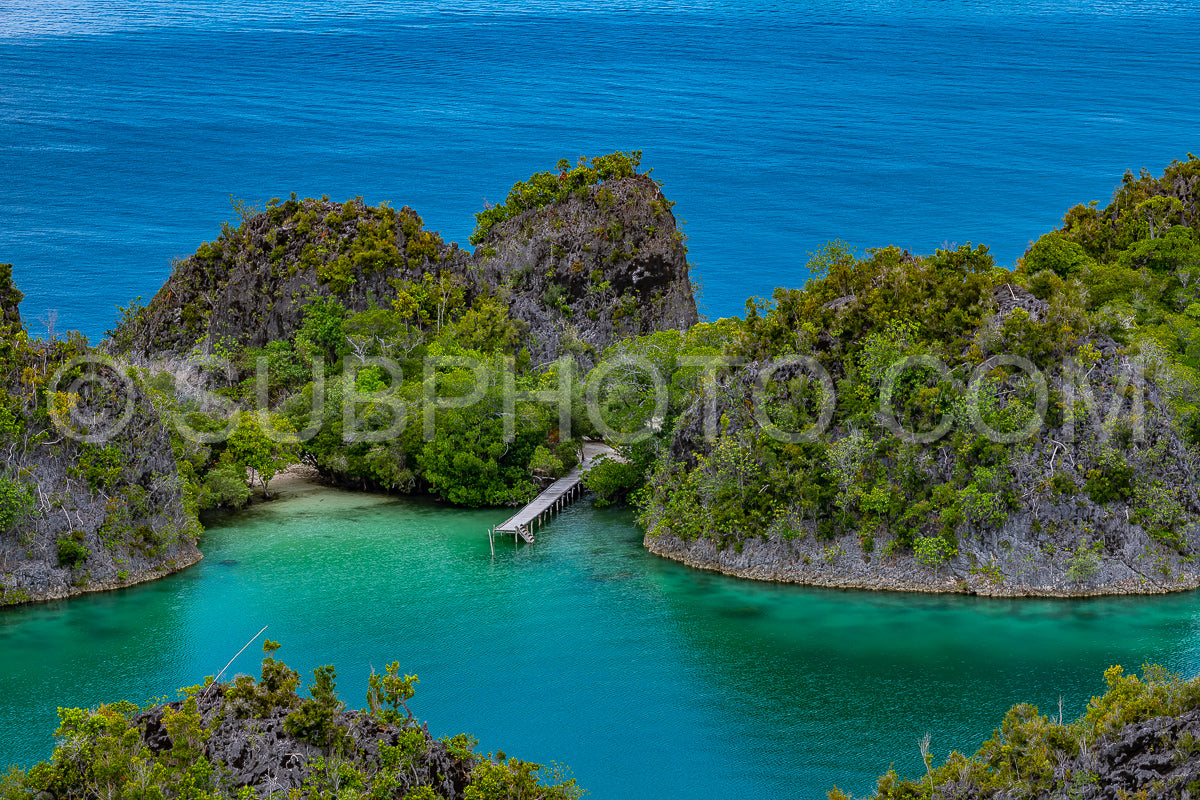 Waigeo- Kri- Mushroom Island- group of small islands in shallow blue lagoon water- Raja Ampat- West Papua- Indonesia