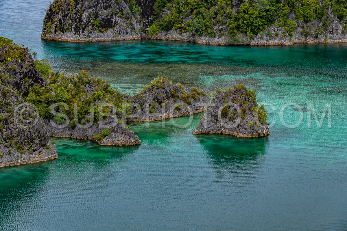 Waigeo- Kri- Mushroom Island- group of small islands in shallow blue lagoon water- Raja Ampat- West Papua- Indonesia