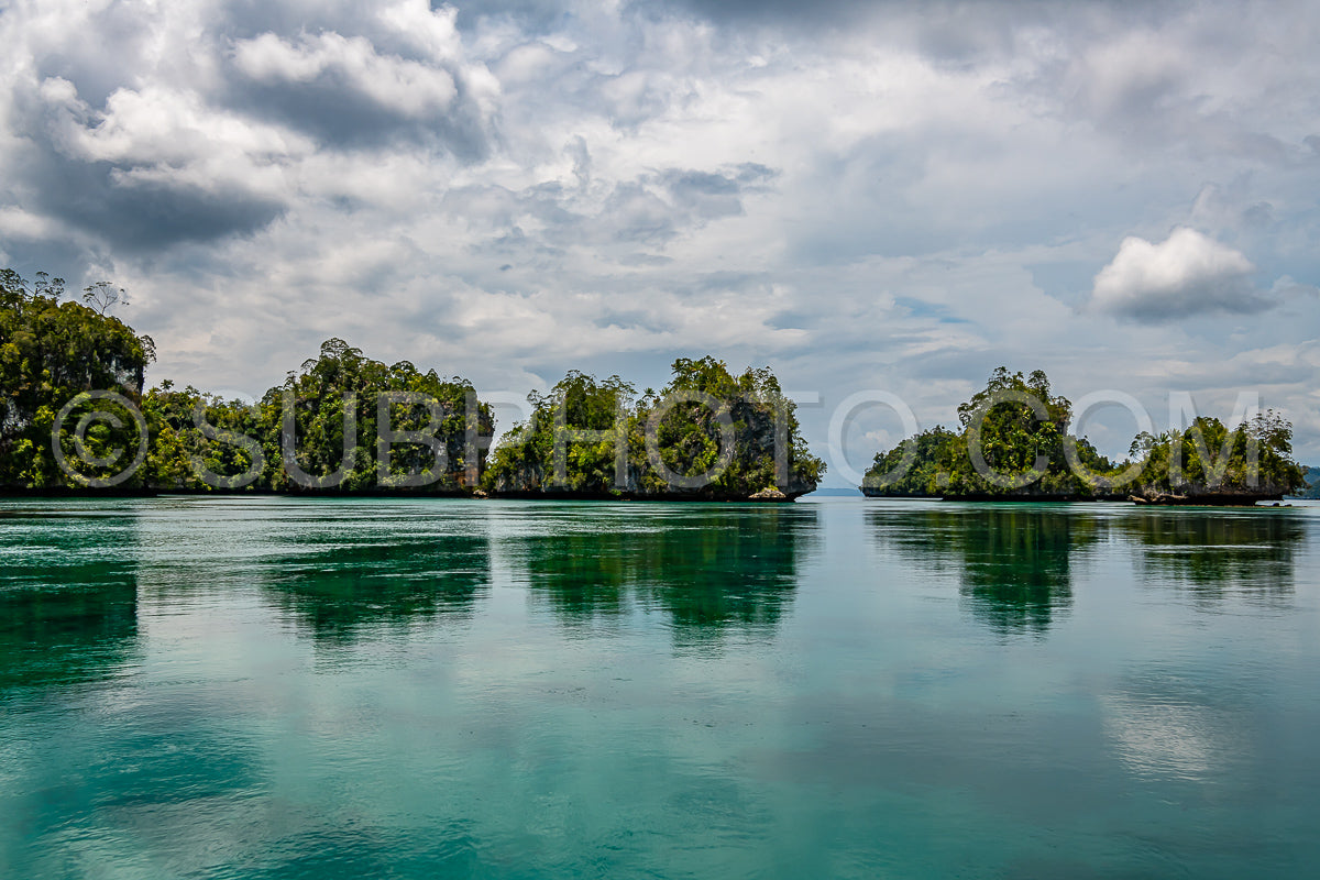 Waigeo- Kri- Mushroom Island- group of small islands in shallow blue lagoon water- Raja Ampat- West Papua- Indonesia