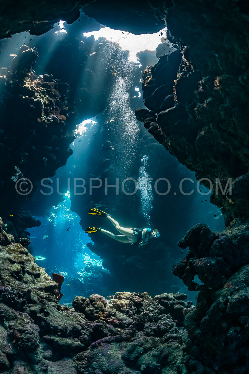 woman diver visiting underwater cave in the Red Sea- egypt- Shaab Claude