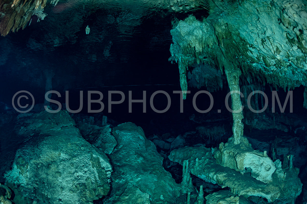 cave diver instructor leading a group of divers in a mexican cenote underwater