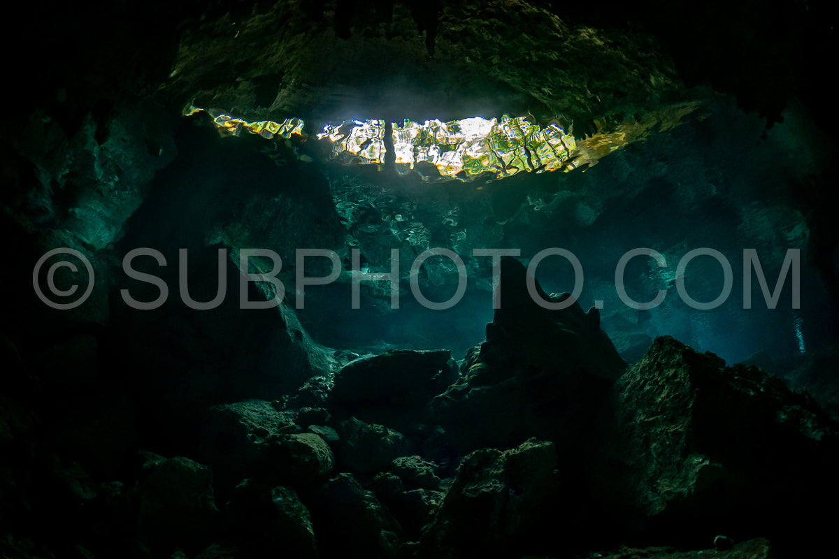 cave diver instructor leading a group of divers in a mexican cenote underwater