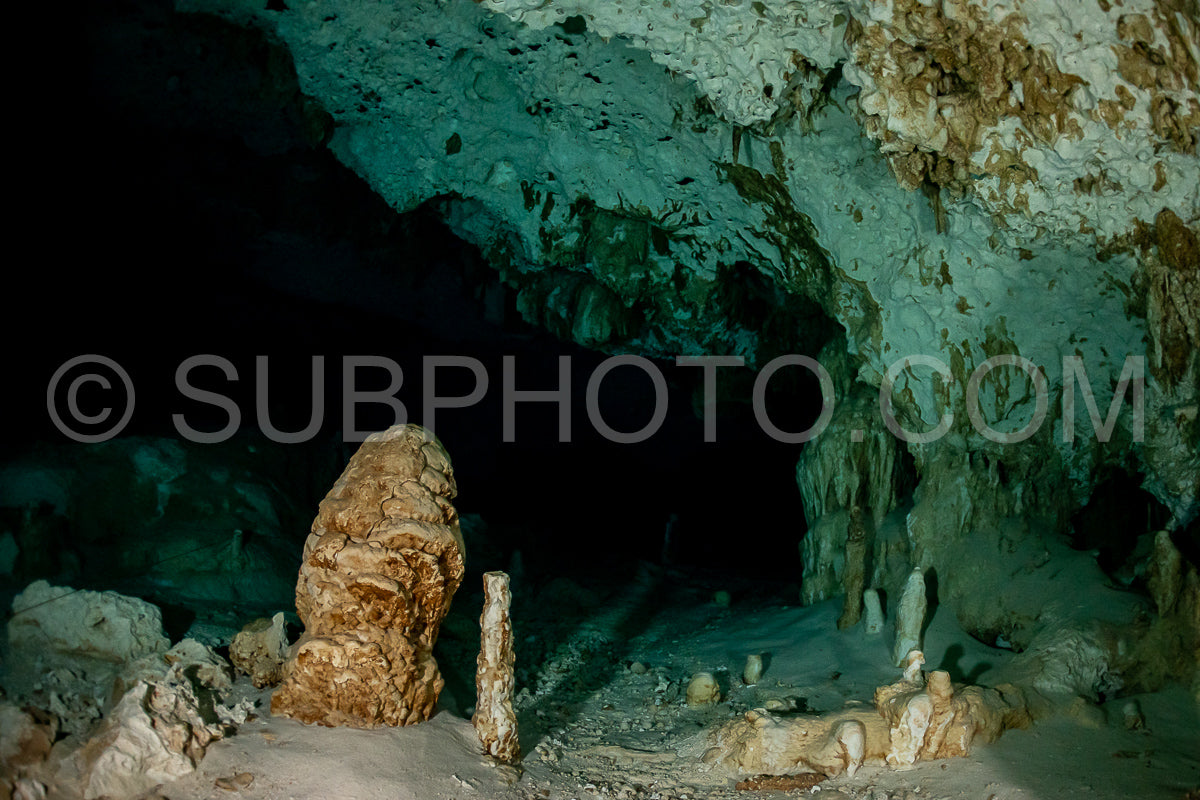 cave diver instructor leading a group of divers in a mexican cenote underwater