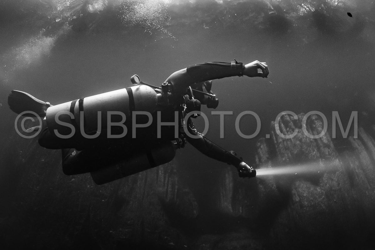 cave diver instructor leading a group of divers in a mexican cenote underwater