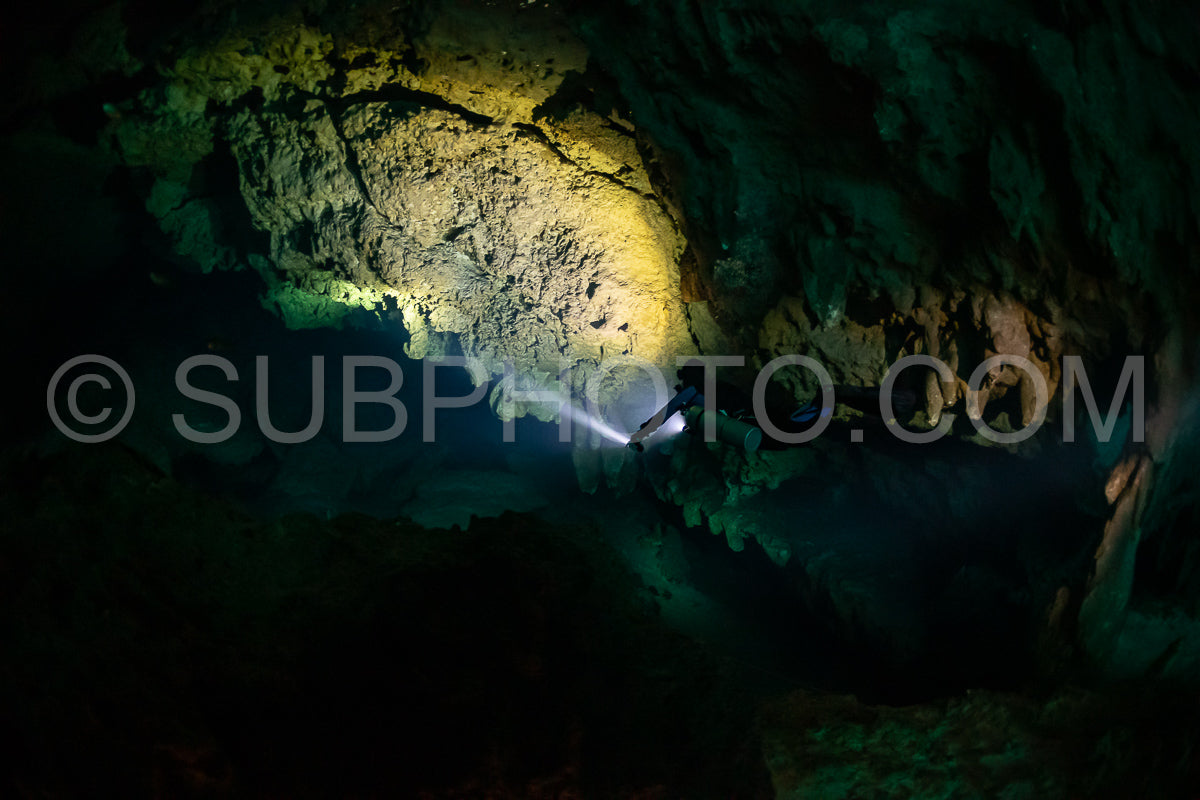 cave diver instructor leading a group of divers in a mexican cenote underwater