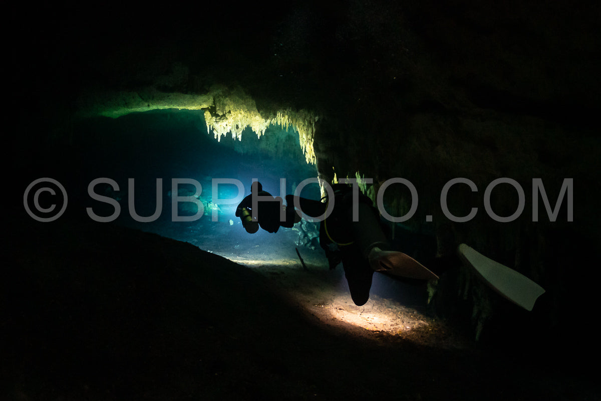 cave diver instructor leading a group of divers in a mexican cenote underwater