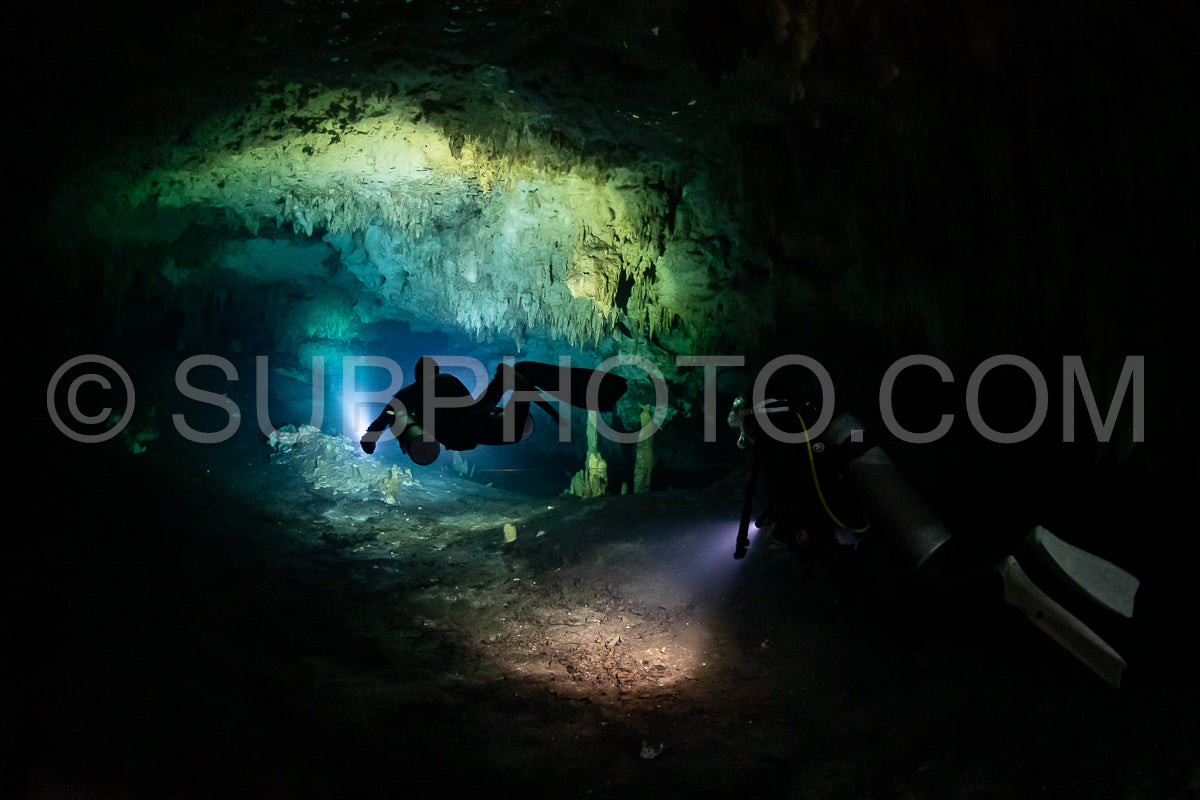 Photo de instructeur de plongée spéléo dirigeant un groupe de plongeurs dans un cenote mexicain sous l'eau