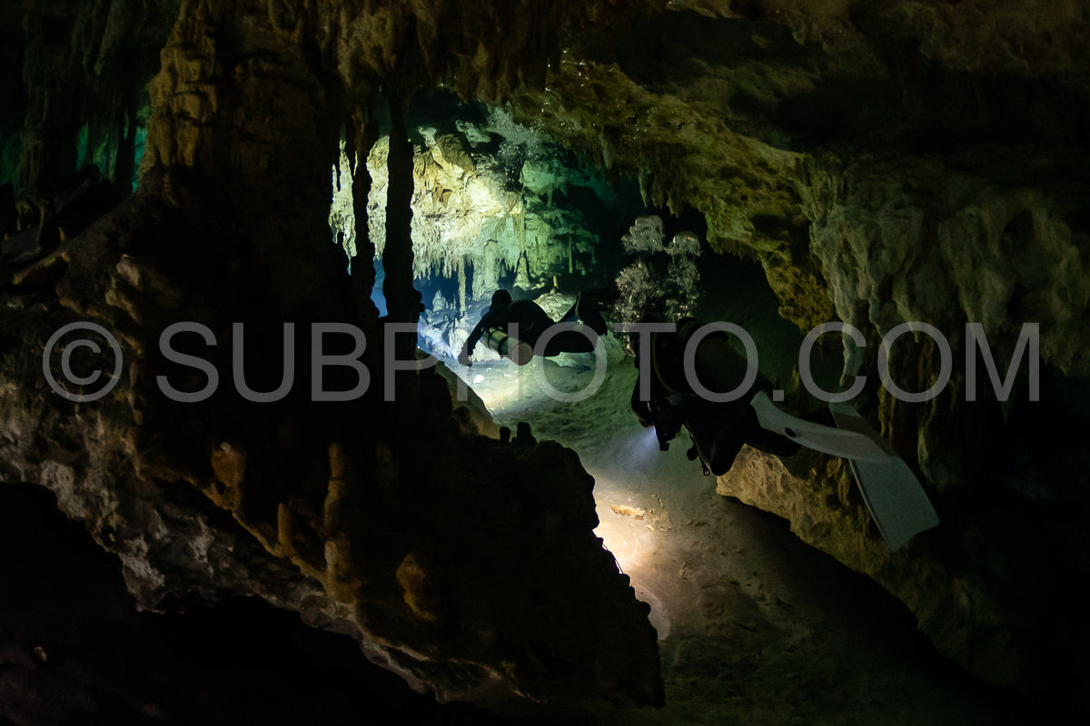Photo de instructeur de plongée spéléo dirigeant un groupe de plongeurs dans un cenote mexicain sous l'eau