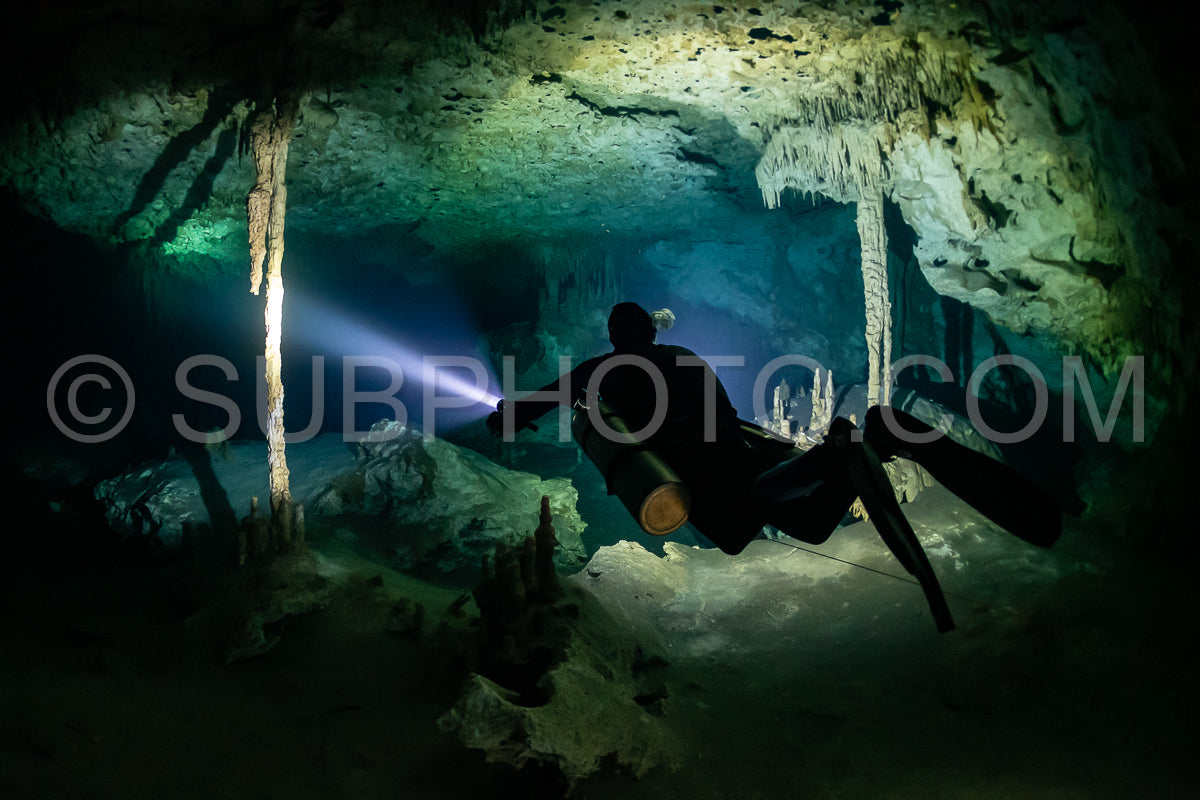cave diver instructor leading a group of divers in a mexican cenote underwater