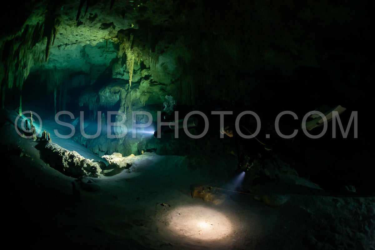 cave diver instructor leading a group of divers in a mexican cenote underwater