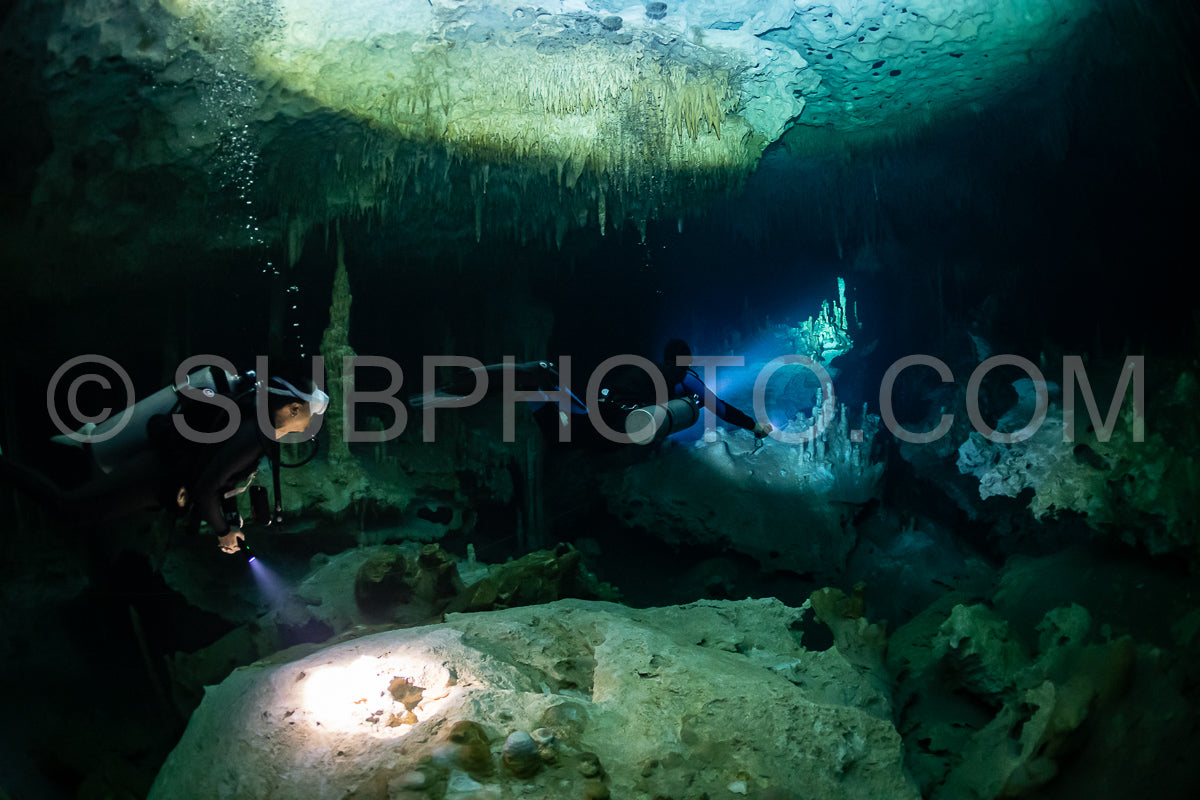 cave diver instructor leading a group of divers in a mexican cenote underwater