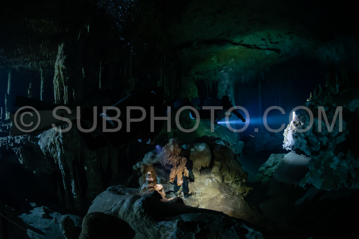 cave diver instructor leading a group of divers in a mexican cenote underwater