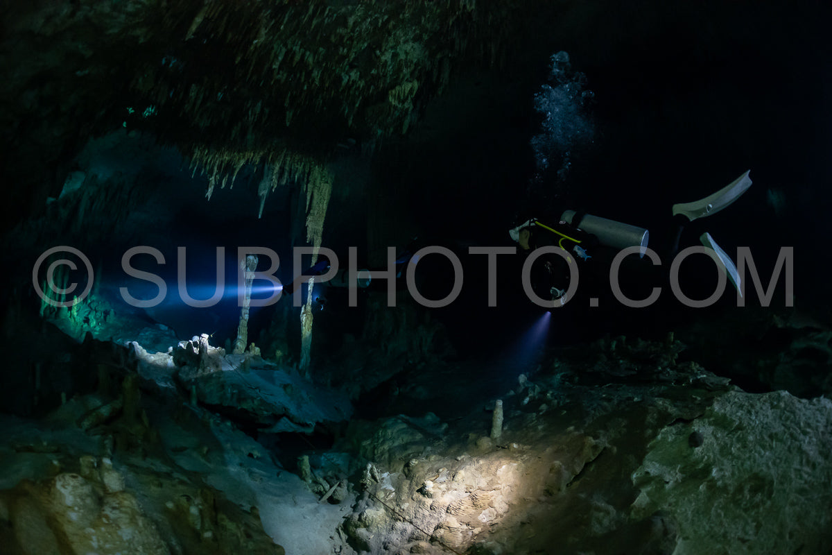 cave diver instructor leading a group of divers in a mexican cenote underwater