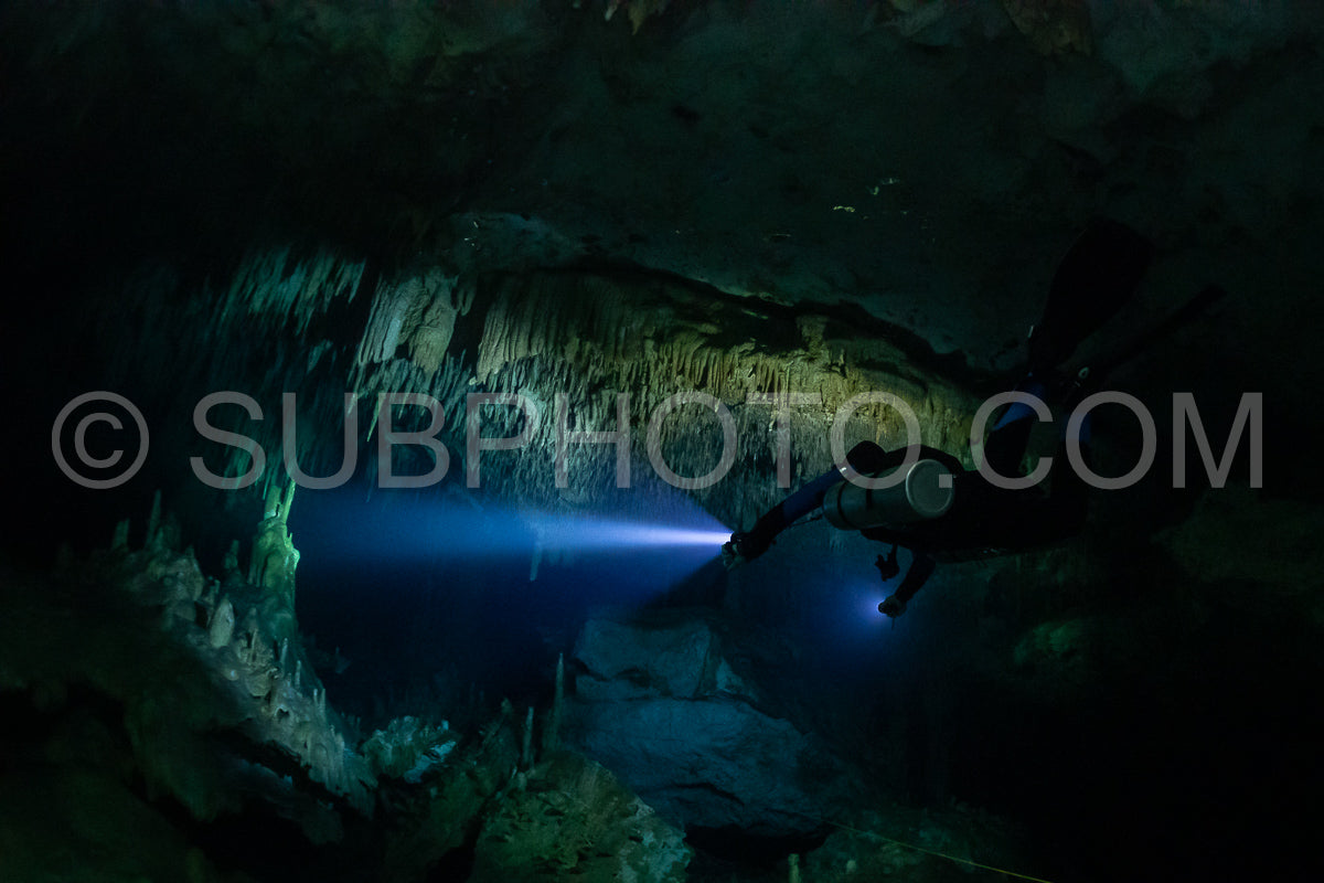 cave diver instructor leading a group of divers in a mexican cenote underwater