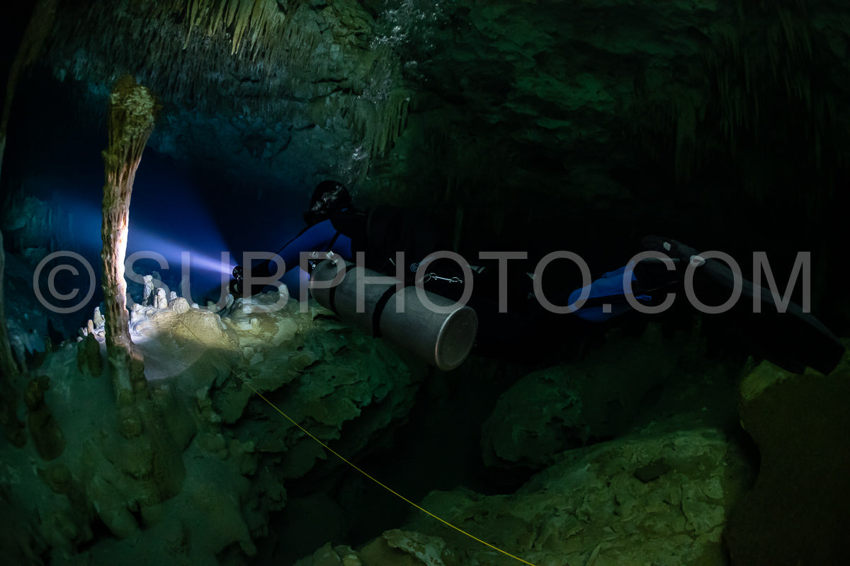 cave diver instructor leading a group of divers in a mexican cenote underwater