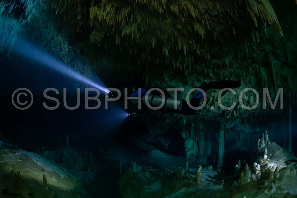 cave diver instructor leading a group of divers in a mexican cenote underwater