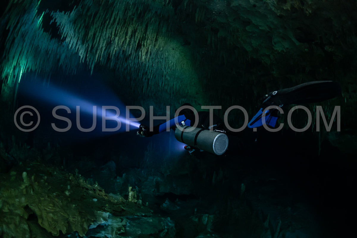 cave diver instructor leading a group of divers in a mexican cenote underwater
