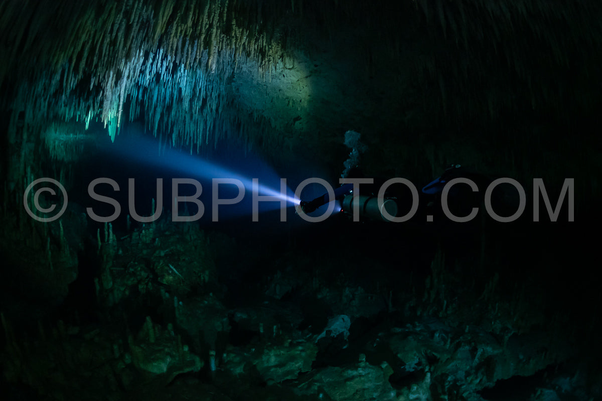 cave diver instructor leading a group of divers in a mexican cenote underwater
