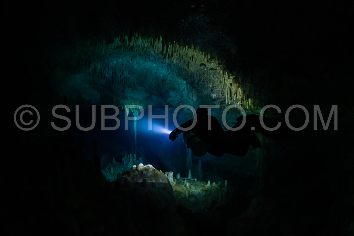 cave diver instructor leading a group of divers in a mexican cenote underwater