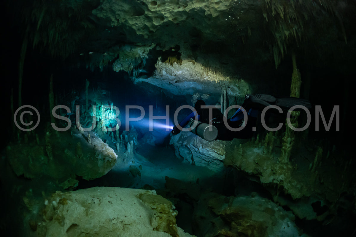 cave diver instructor leading a group of divers in a mexican cenote underwater