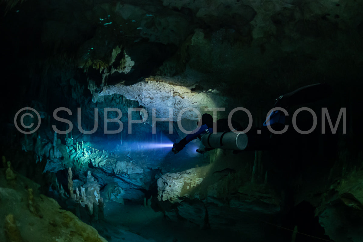 cave diver instructor leading a group of divers in a mexican cenote underwater
