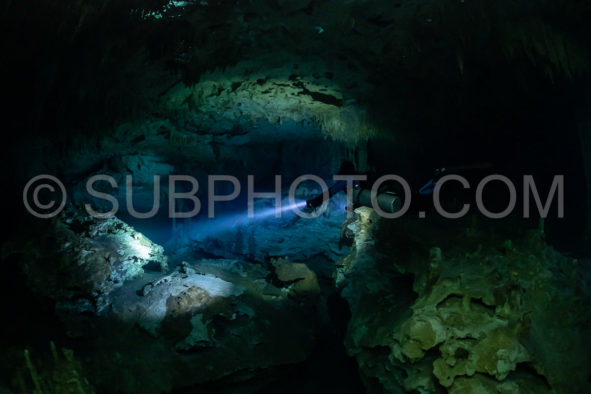 cave diver instructor leading a group of divers in a mexican cenote underwater