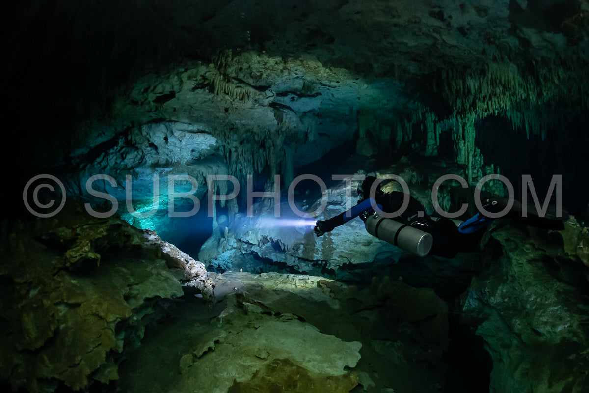 cave diver instructor leading a group of divers in a mexican cenote underwater