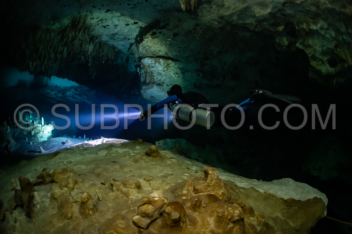 cave diver instructor leading a group of divers in a mexican cenote underwater
