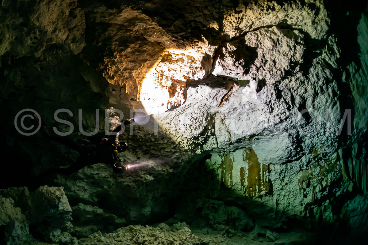 cave diver instructor leading a group of divers in a mexican cenote underwater