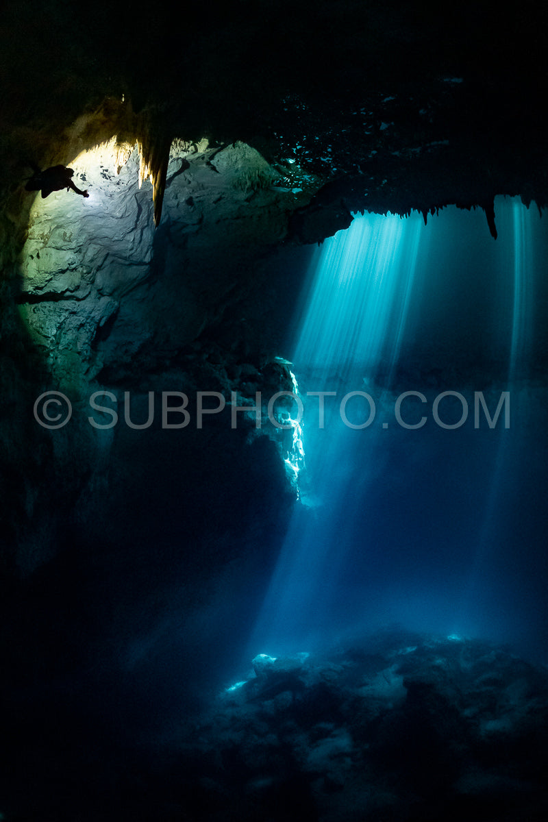 cave diver instructor leading a group of divers in a mexican cenote underwater