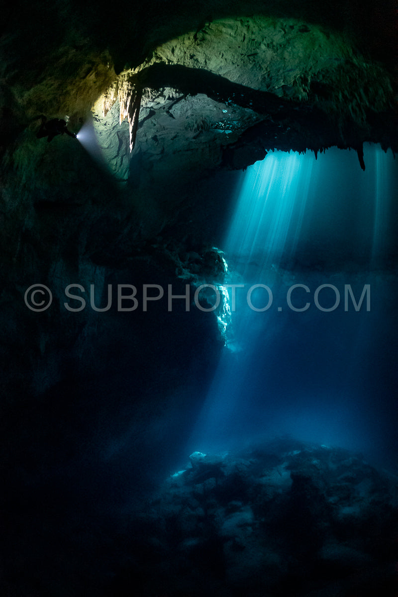 cave diver instructor leading a group of divers in a mexican cenote underwater