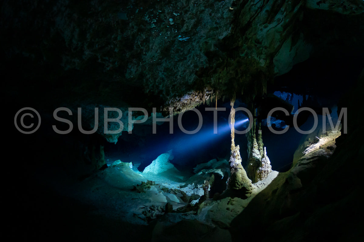 cave diver instructor leading a group of divers in a mexican cenote underwater