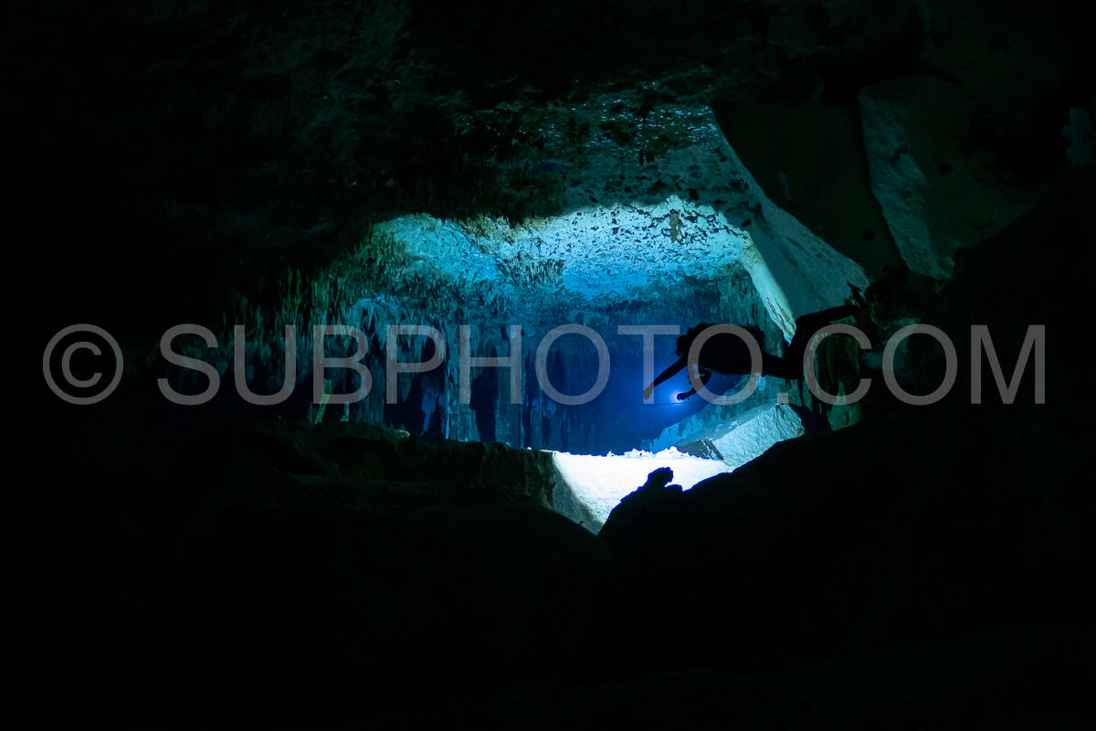 cave diver instructor leading a group of divers in a mexican cenote underwater