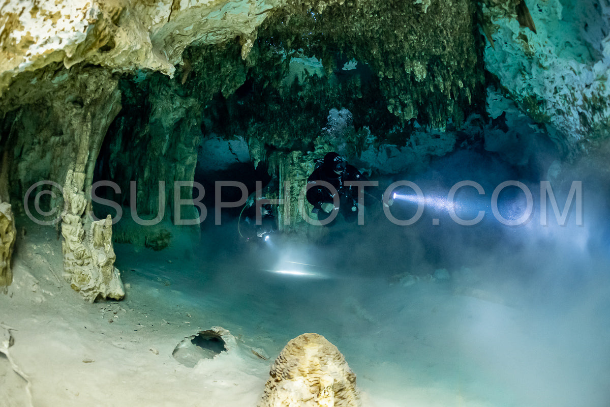 cave diver instructor leading a group of divers in a mexican cenote underwater