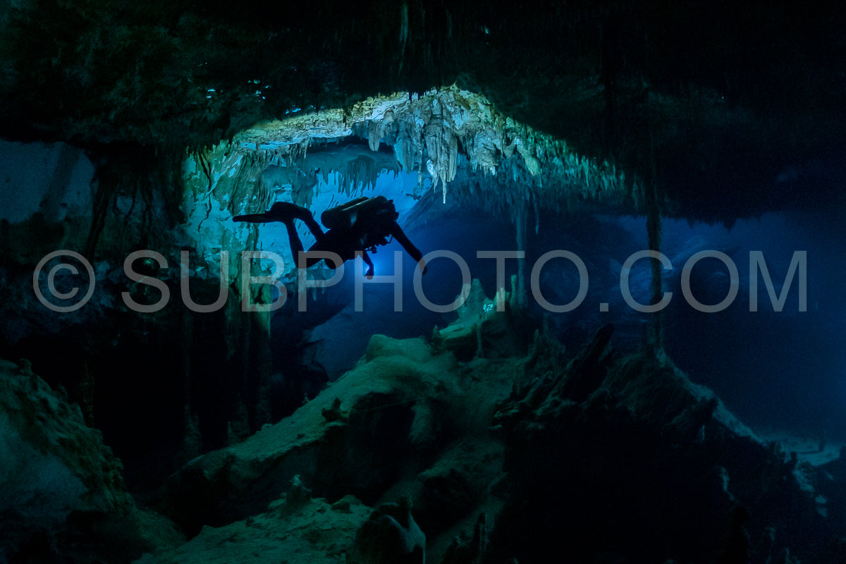 cave diver instructor leading a group of divers in a mexican cenote underwater