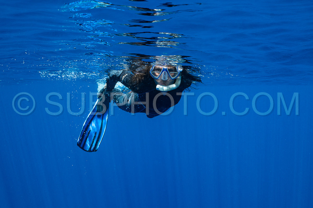 woman snorkeling in polynesian deep waters