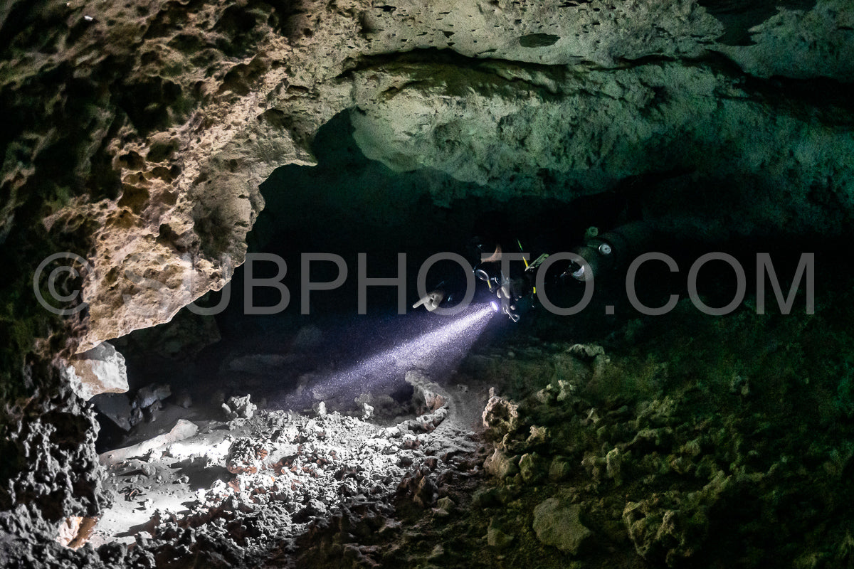 cave diver instructor leading a group of divers in a mexican cenote underwater