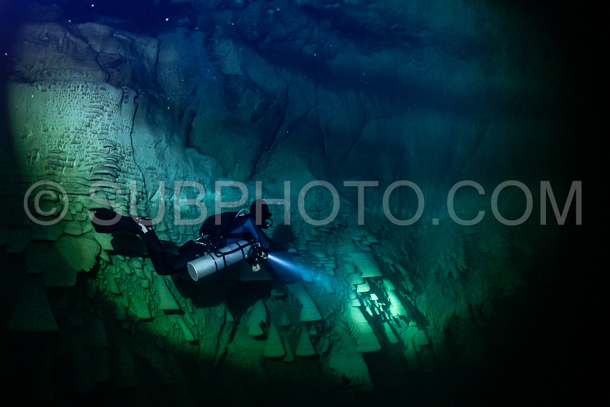cave diver instructor leading a group of divers in a mexican cenote underwater