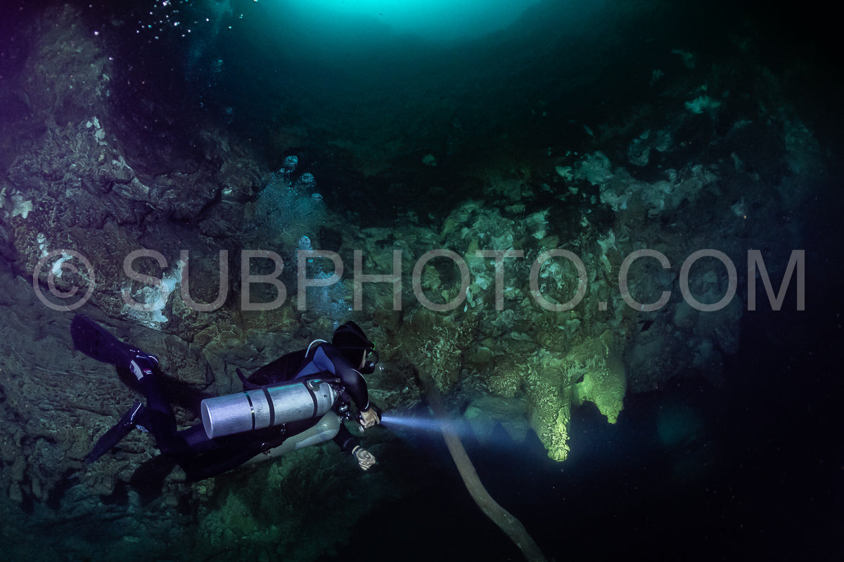 cave diver instructor leading a group of divers in a mexican cenote underwater