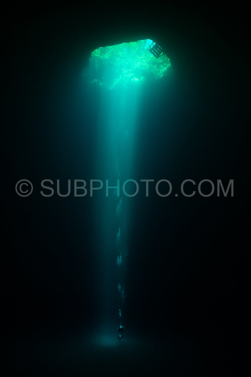 cave diver instructor leading a group of divers in a mexican cenote underwater