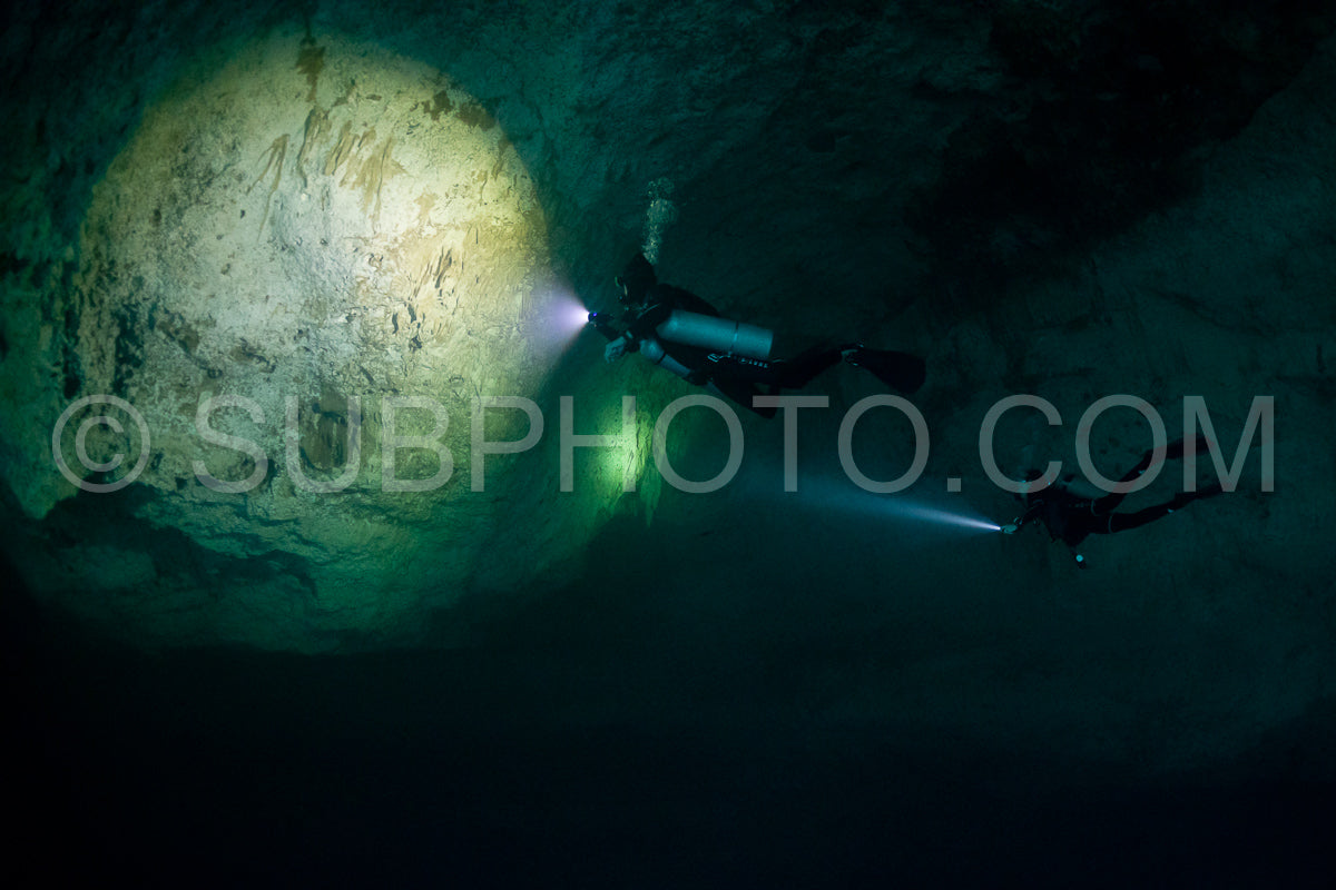cave diver instructor leading a group of divers in a mexican cenote underwater