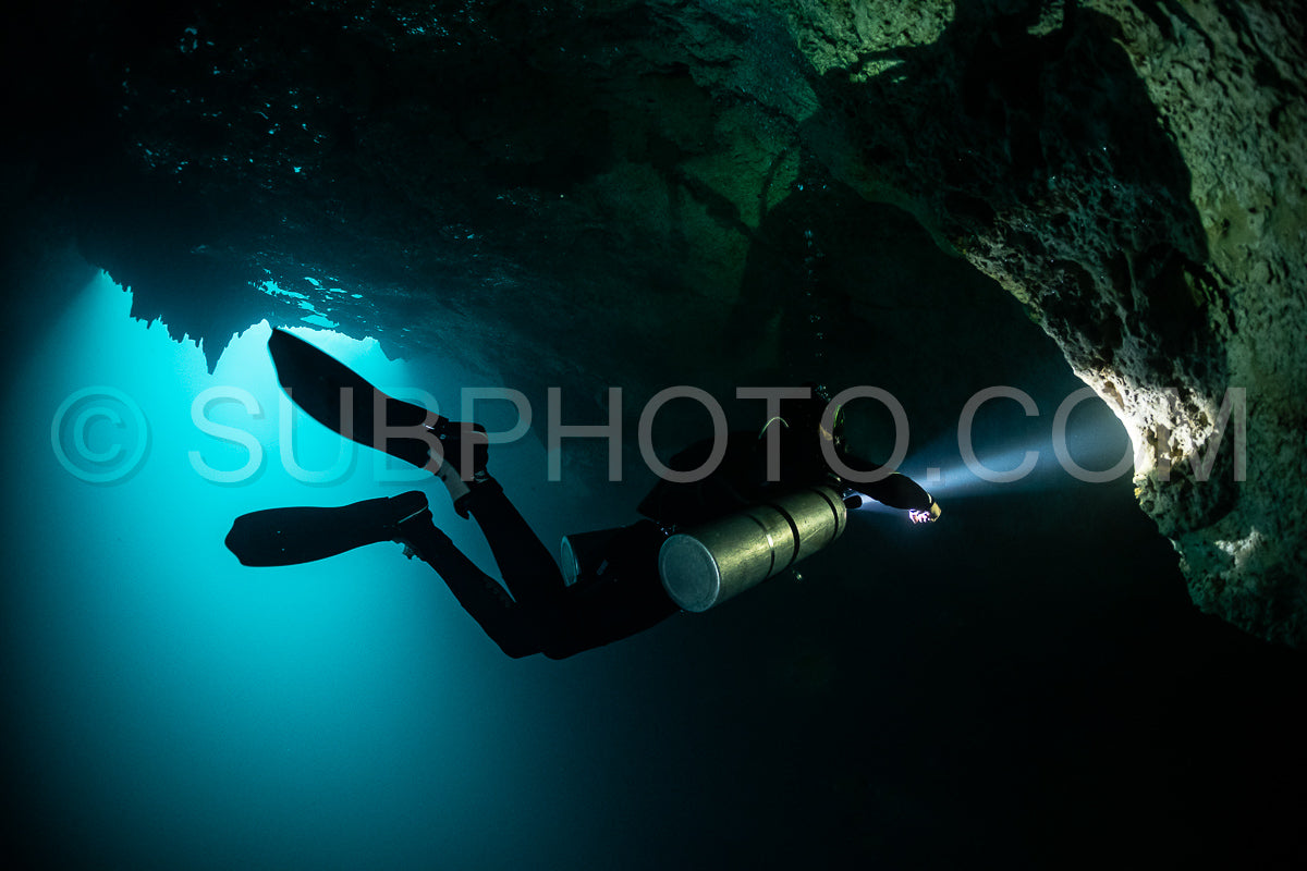 cave diver instructor leading a group of divers in a mexican cenote underwater