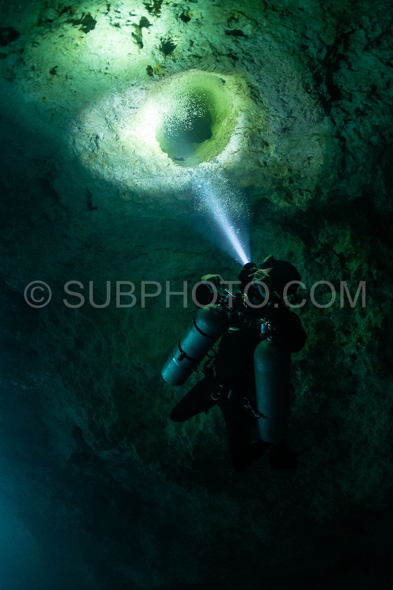 cave diver instructor leading a group of divers in a mexican cenote underwater