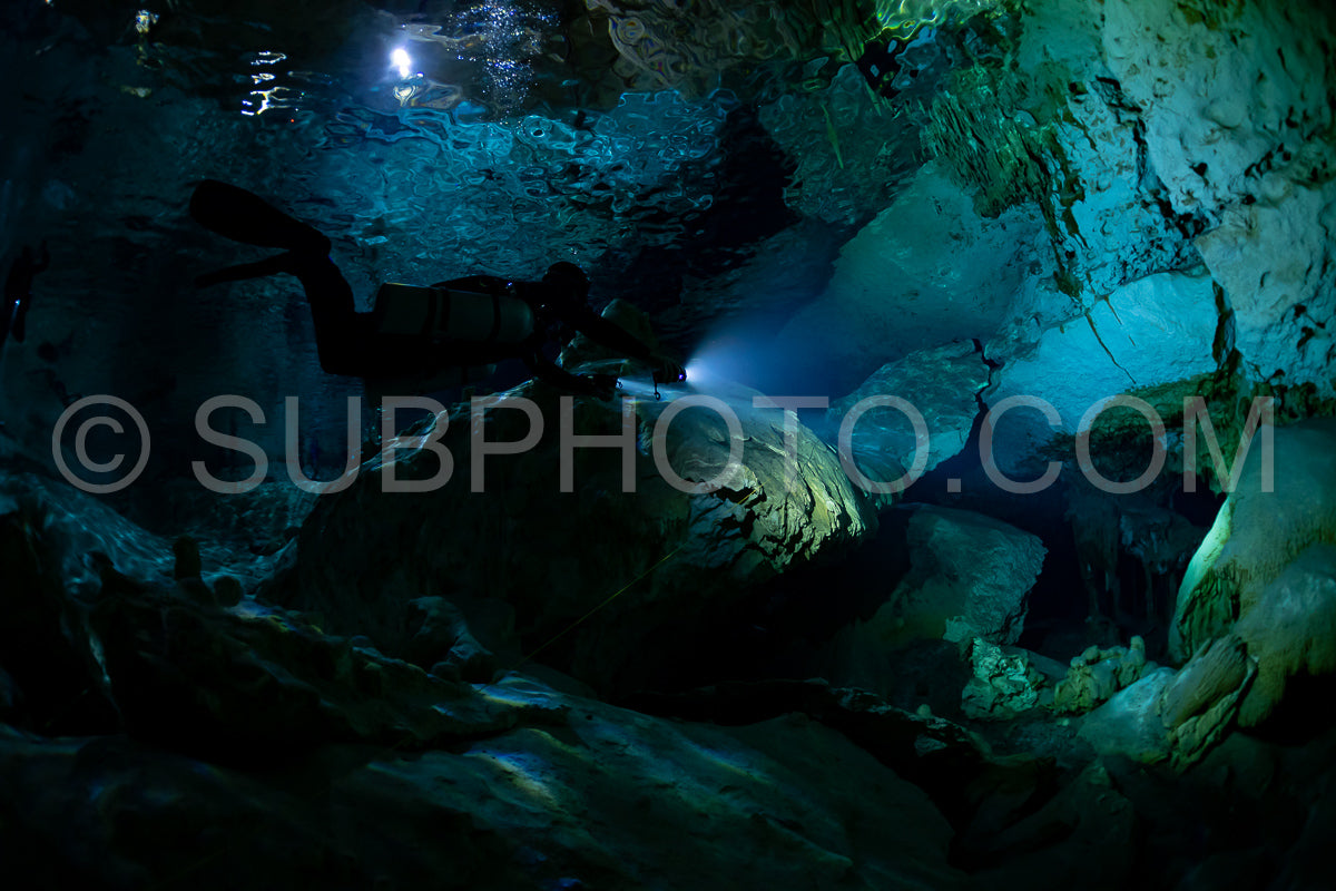 cave diver instructor leading a group of divers in a mexican cenote underwater
