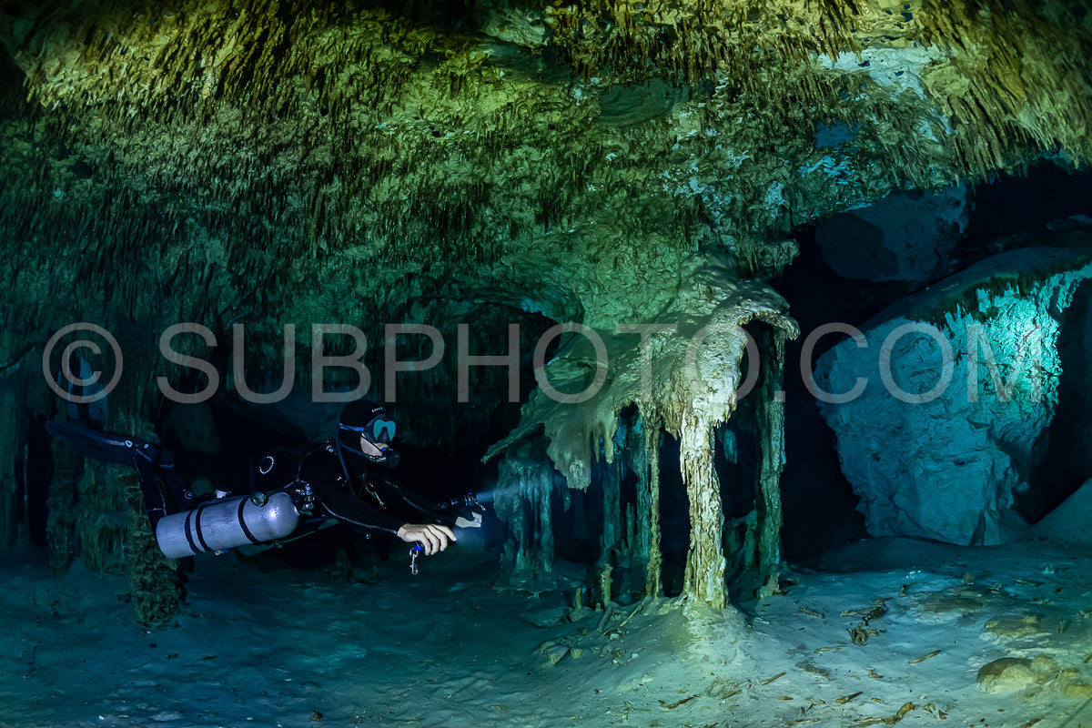 cave diver instructor leading a group of divers in a mexican cenote underwater