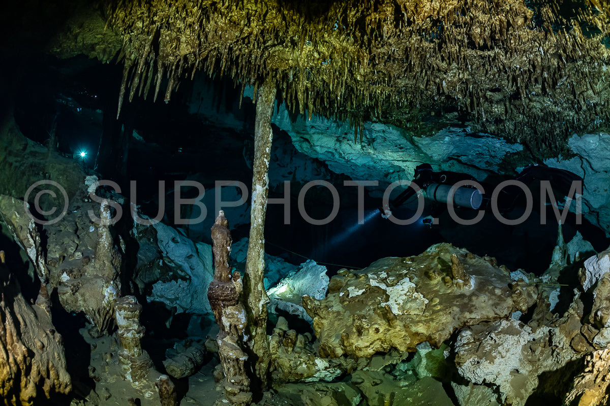cave diver instructor leading a group of divers in a mexican cenote underwater