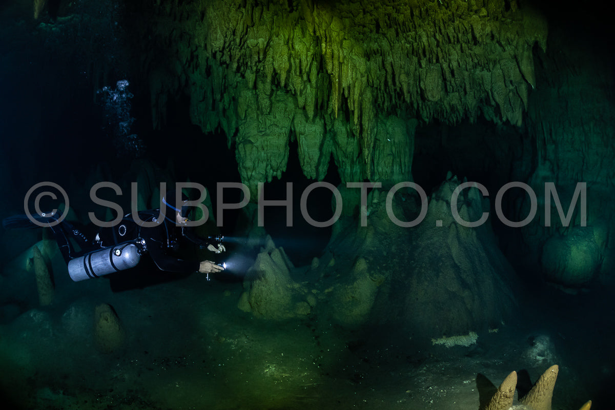 cave diver instructor leading a group of divers in a mexican cenote underwater